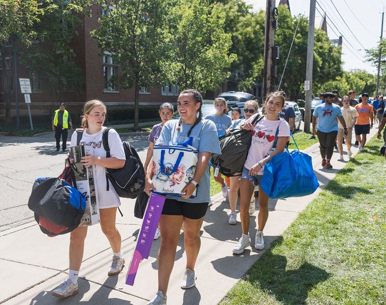 A long line of Case Western Reserve University students help move items into residence halls
